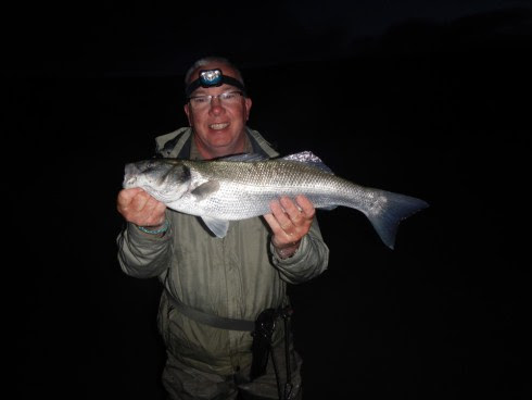 Martin’s fishing mate Paul with a dawn caught bass from an Irish surf beach